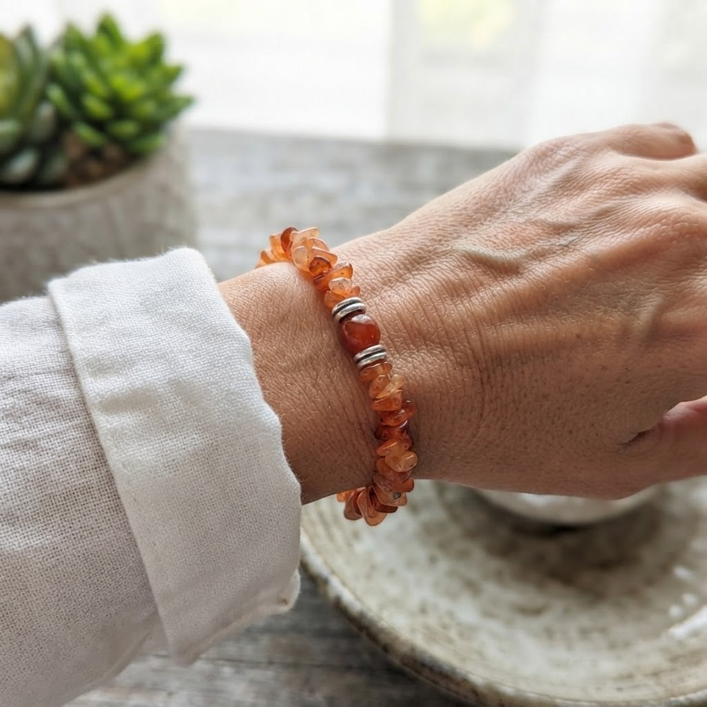 Orange Carnelian Crystal Chip Beaded Bracelet with Round Gemstone Center Bead Styled on Wrist – Trendy Natural Stone Jewelry | OneTrend India