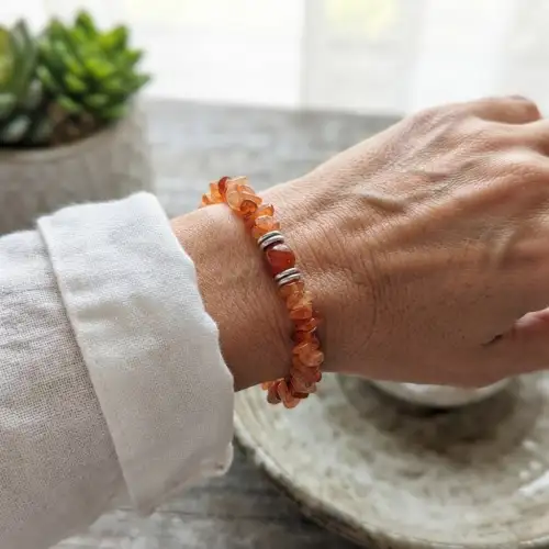 Natural Carnelian Crystal Chip Bracelet with Orange Gemstone Beads, Round Carnelian Center Stone and Silver Spacers on Beige Fabric | OneTrend India - 2nd View